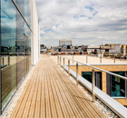 Treated softwood decking for mixed-use development