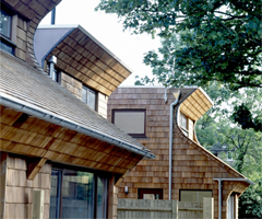 Sustainable roof to wall shingle cladding for housing trust
