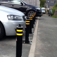 Manually retractable bollards for residential parking protection