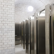Brushed stainless steel cubicles at Royal Academy of Arts