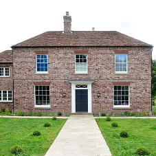 New slim box sash windows help retain the character of this West Sussex home