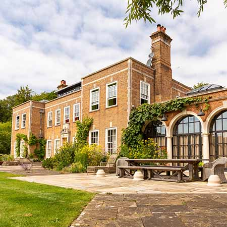 Arched head steel doors make a spectacular feature at this 20th Century Country House