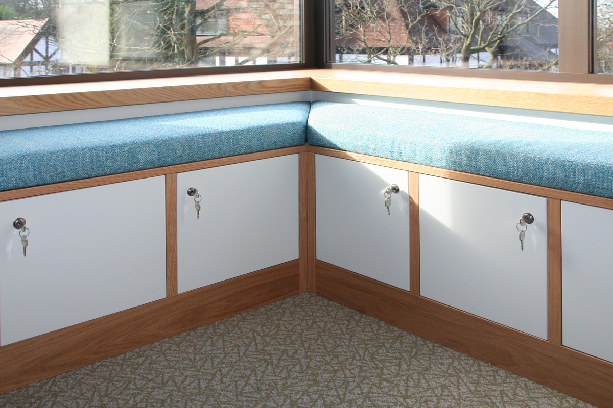 Upholstered Seating Detail with Fitted Storage Cabinets