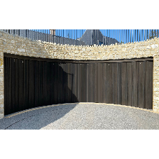 Concave sliding door creates unique curved garage space in redevelopment project
