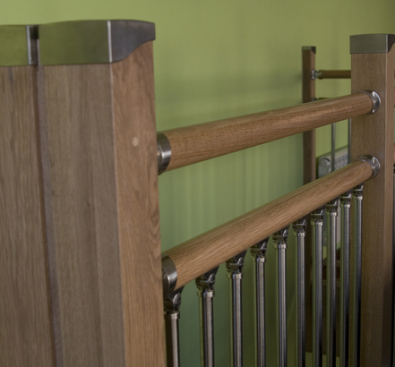 Minimalist oak handrails and sleek tubular balusters in a modern brushed-nickel finish