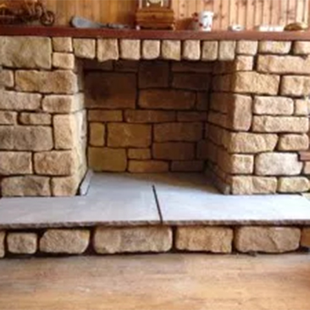 Cast stone cladding for fireplace